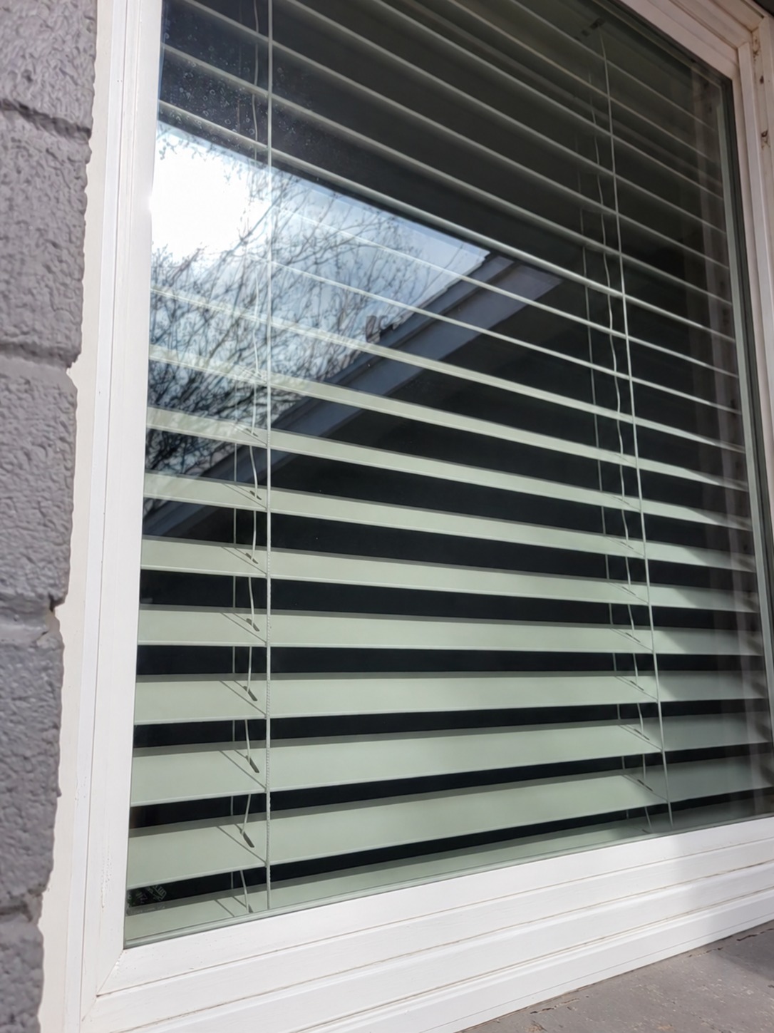 The residential window after cleaning, with clear glass and visible reflections